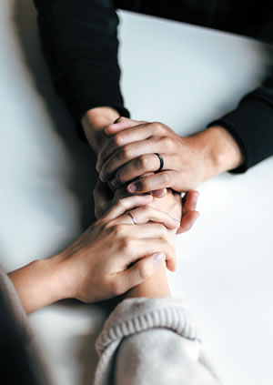 two people clasping hands