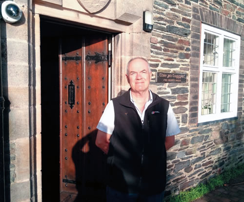 Fr. John Boles at the entrance to the church presbytery