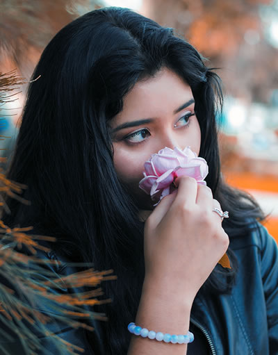 woman smelling a flower