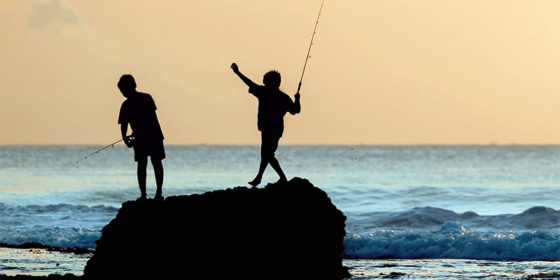 Children fishing from a rock