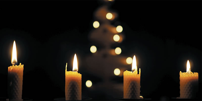 lit candles in a darkened church