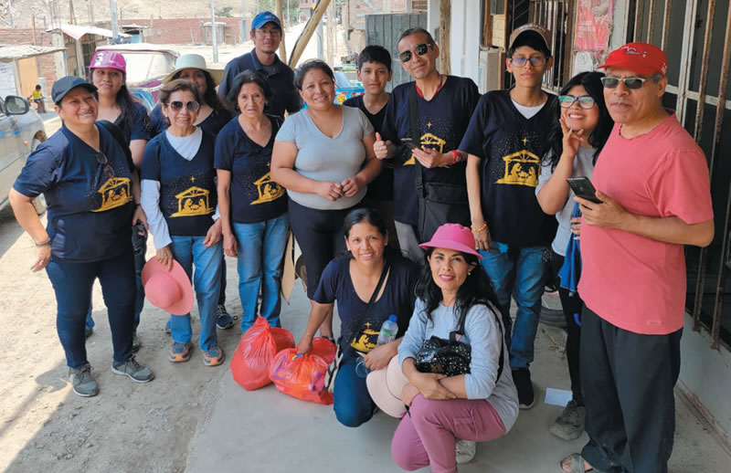 Holy Archangels Choir members distribute food aid.