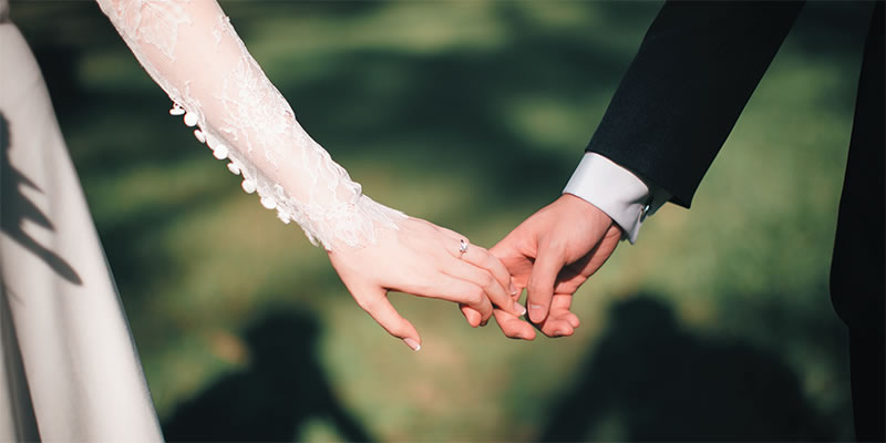 Bride and groom holding hands