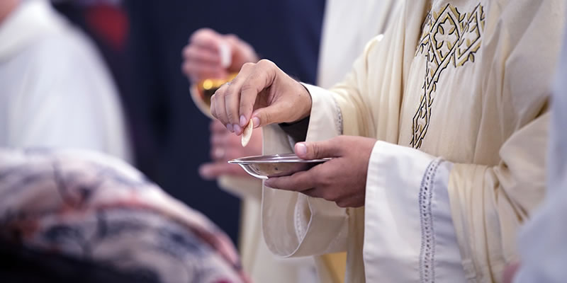 Catholic priest giving communion