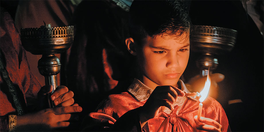 Child lighting a candle