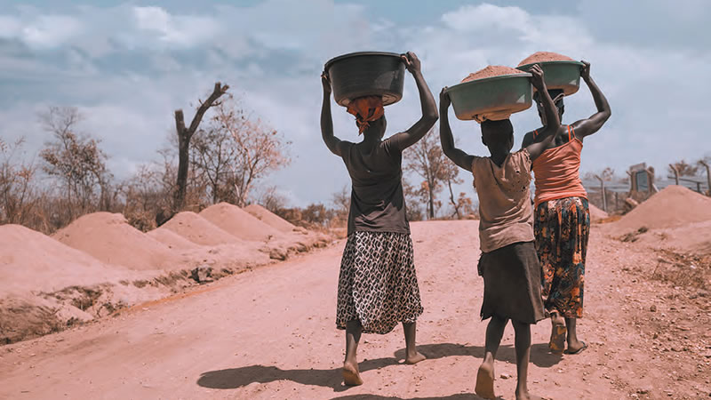 villagers walking down a road