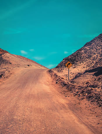 Winding lifeless mountain road