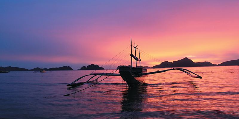 canoe on the water at sunset