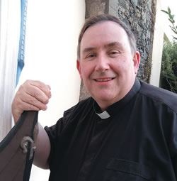 Fr. Philip Gillespie beside the &quot;oar-less coracle&quot;