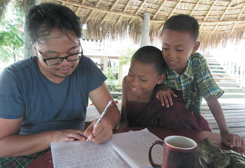 Fr. Kurt learning Burmese with Buddhist novices monks