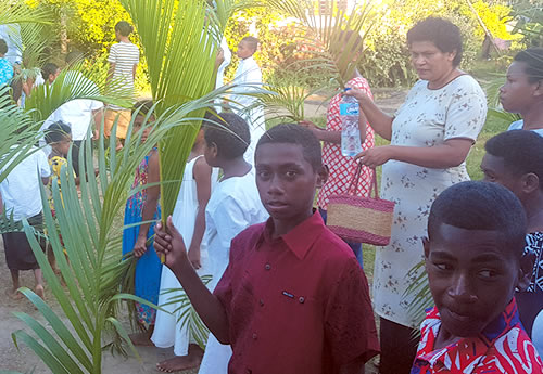 Children, families holding palms