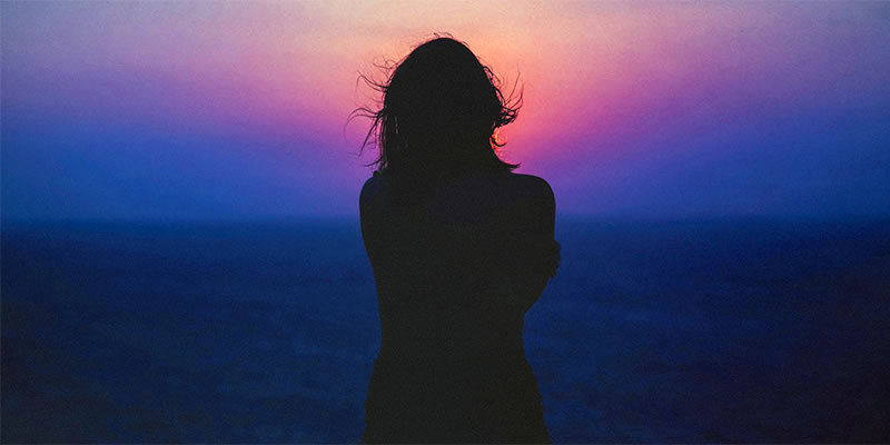 Woman staring into the sunset