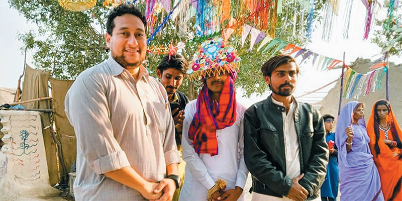 Fr. Pat Visanti (left) dressed in the traditional shalwar kamiz with friends