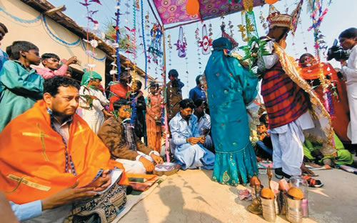 Fr. Pat Visanti (left) during a Pakhari Kholl wedding