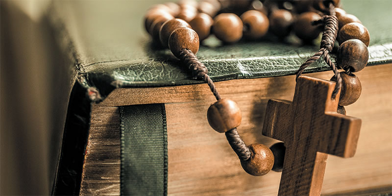 Rosary draped over a bible