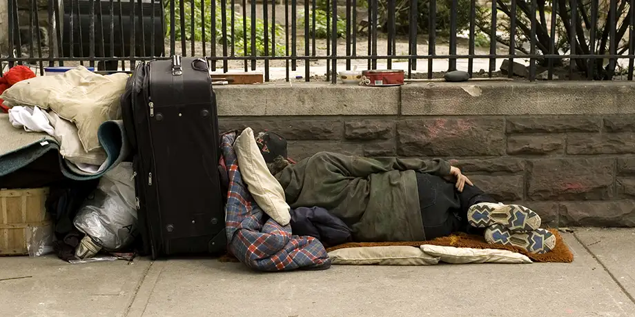 Homeless person sleeping on park bench