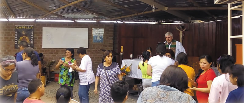 Columban Fr. Ed O’Connell and parishioners before Mass