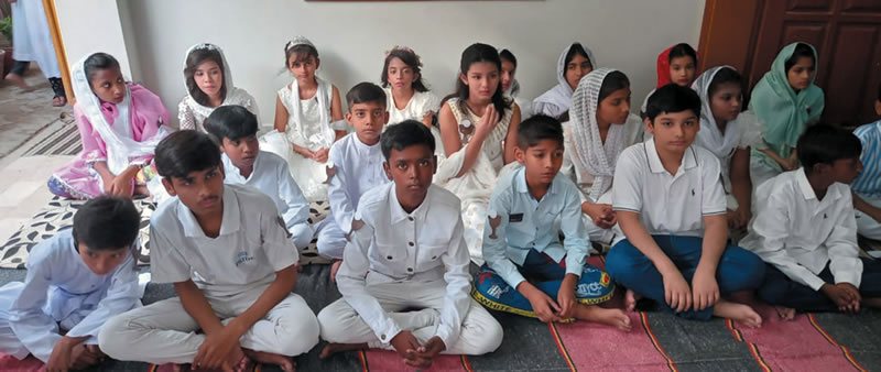 Children seated on the floor at St. John the Apostle Chruch