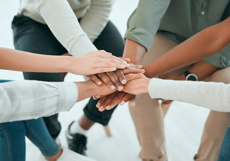 Hands clasped together in a sign of diversity.