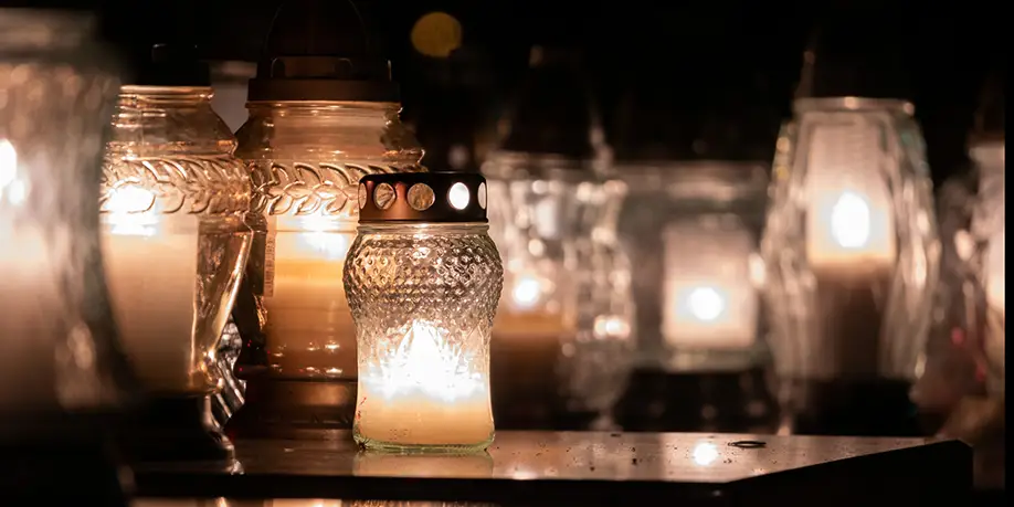 candles burn in a memorial to the deceased