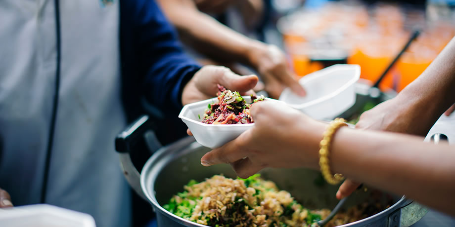 Volunteers feed refugees and migrants.