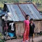 Andonie's children Melanie and Bernabe in front of their home.