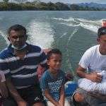 People on a boat carrying Sonny Boy's ashes for scattering in the sea