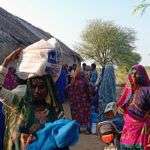 A woman carries her food rations in Mariam Nagar Village in Bangli.