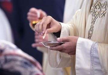 Catholic priest giving communion