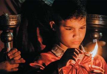 Child lighting a candle