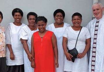 Parishioners with Fr. Carlo (left) and Fr. Tim